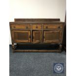 An early 20th century carved oak sideboard