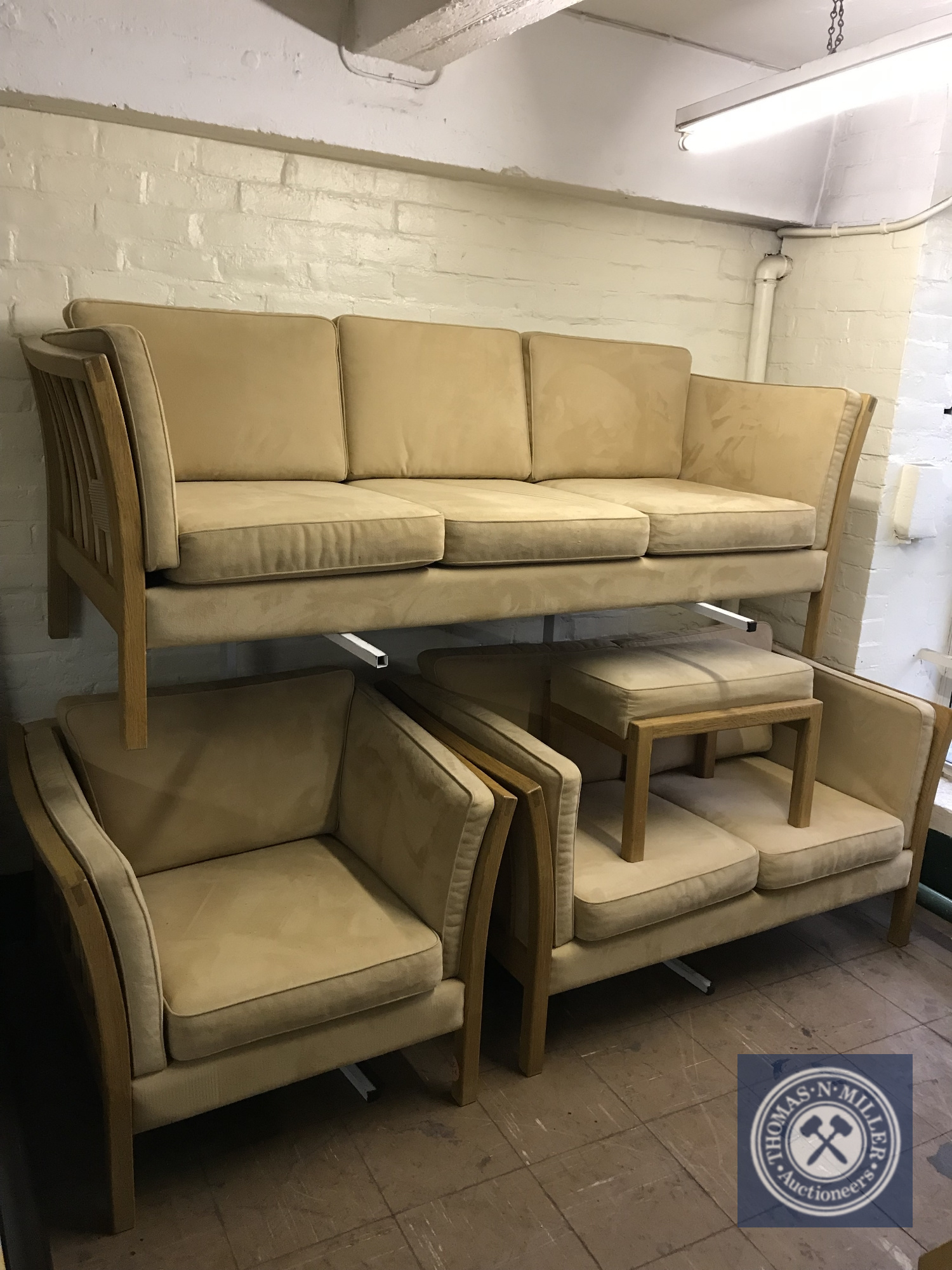 A late twentieth century wooden framed lounge suite comprising of three seater sofa,