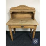 An early 20th century oak writing table with shelf fitted a drawer