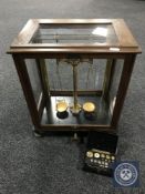 A set of cased chemist's scales and a set of Bakelite cased micro weights