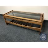 A late twentieth century teak glass topped coffee table with under shelf