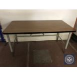 A mid 20th century office table on metal legs