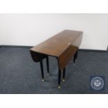 A late 20th century drop leaf table