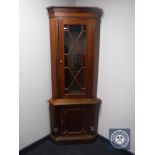 A mahogany glazed door corner display cabinet