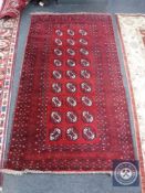 An Afghan Tekke rug on red ground,