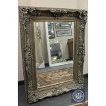 An ornate silvered bevelled mirror,