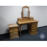 A pine dressing table together with three drawer bedside chest