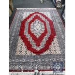 An Eastern design carpet on red ground,