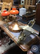 A brass light fitting in the form of an oil lamp,