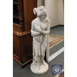 A plaster figure depicting a scantily clad maiden,