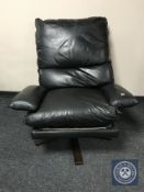 A 20th century continental black leather swivel armchair