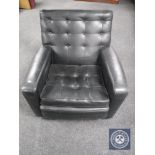 A mid 20th century black buttoned vinyl armchair