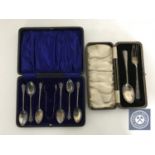 A set of six cased sterling silver teaspoons with sugar tongs and a cased silver fork and spoon
