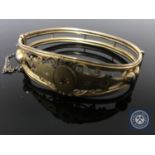 A Victorian gilt metal and synthetic ruby bangle