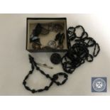 A box of assorted jewellery including Whitby Jet necklace and brooch, cross pendant,