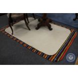 A hand tufted contemporary rug with multi coloured border,