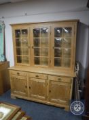 A blonde oak triple door dresser