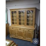 A blonde oak triple door dresser