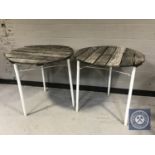 A pair of wooden cafe tables on metal legs