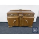 An early 20th century carved oak sideboard