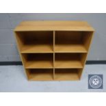 A set of blonde oak cube shelves