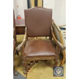 A carved oak 17th century style armchair in brown studded leather