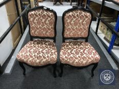 A pair of mahogany framed dining chairs upholstered in a pink floral brocade