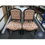 A pair of mahogany framed dining chairs upholstered in a pink floral brocade