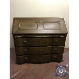 A late nineteenth century serpentine fronted bureau on claw and ball feet fitted with three drawers