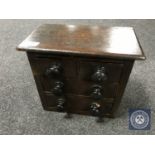 A 19th century miniature four drawer pine chest