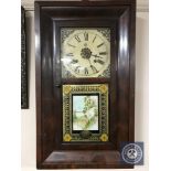 An early 20th century American cased wall clock with pendulum and weights