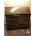 A late nineteenth century oak bureau fitted with four drawers