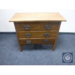 An Edwardian oak three drawer chest