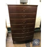 A mid twentieth century teak bow fronted seven drawer chest