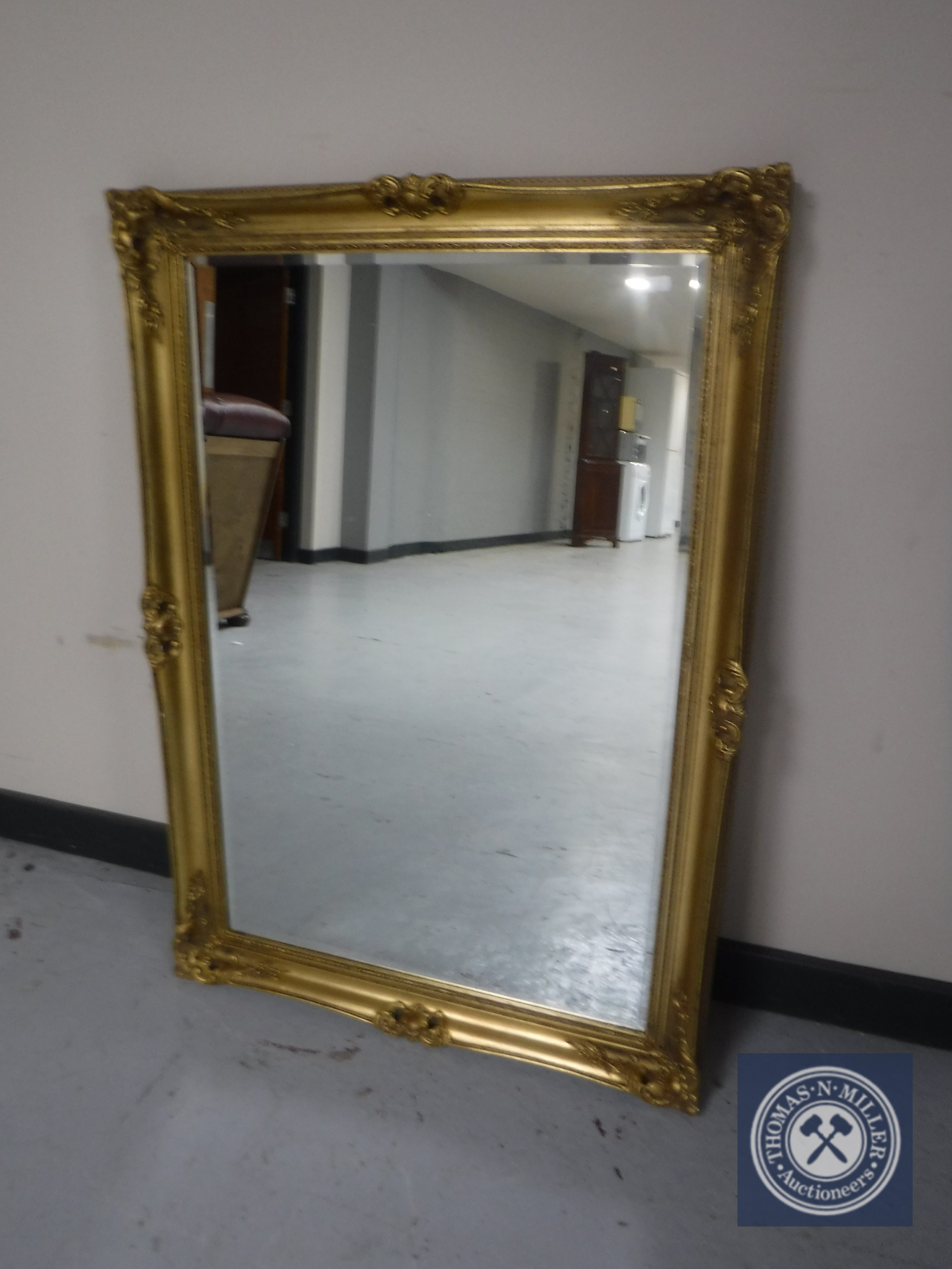 A gilt framed bevelled wall mirror CONDITION REPORT: 106cm by 75cm.