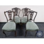 A set of four late Victorian mahogany dining chairs of cabriole legs