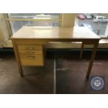 A mid twentieth century single pedestal desk fitted with three drawers