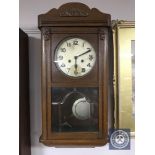 A 20th century oak wall clock with silvered dial,