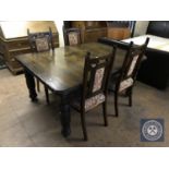 A nineteenth century carved oak wind out dining table together with five later high backed chairs