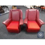 A pair of mid 20th century red vinyl armchairs