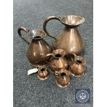 A graduated set of six copper jugs