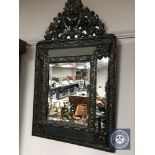 A 20th century metal framed cushion mirror