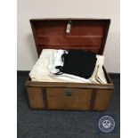 An early twentieth century tin trunk containing bedding and linen, wool blanket,