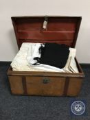 An early twentieth century tin trunk containing bedding and linen, wool blanket,