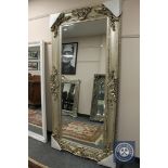 A champagne coloured leaning mirror,