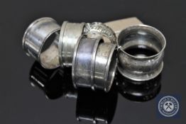 Six silver napkin rings including a matching pair.