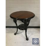 A circular Britannia pub table on cast iron base