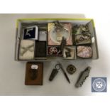 A box of assorted costume jewellery, brooches, Mauchline Bamburgh Castle box, wine bottle stopper,