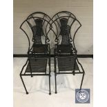 A set of four wrought iron dining chairs