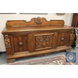 A continental carved oak sideboard,